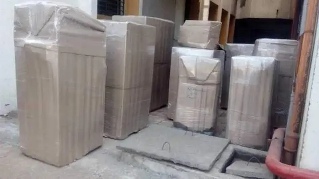 Furniture wrapped in protective sheets for home shifting
