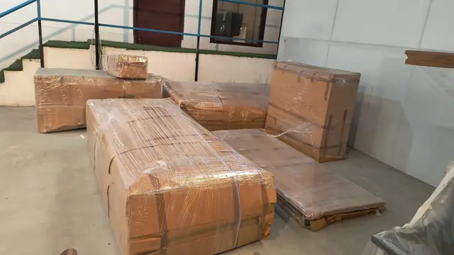 Sofa set packed in corrugated sheet and tape